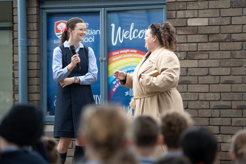 Junior School Sports Coordinator Miss Hackfath interviews Zoe at the Junior School assembly
